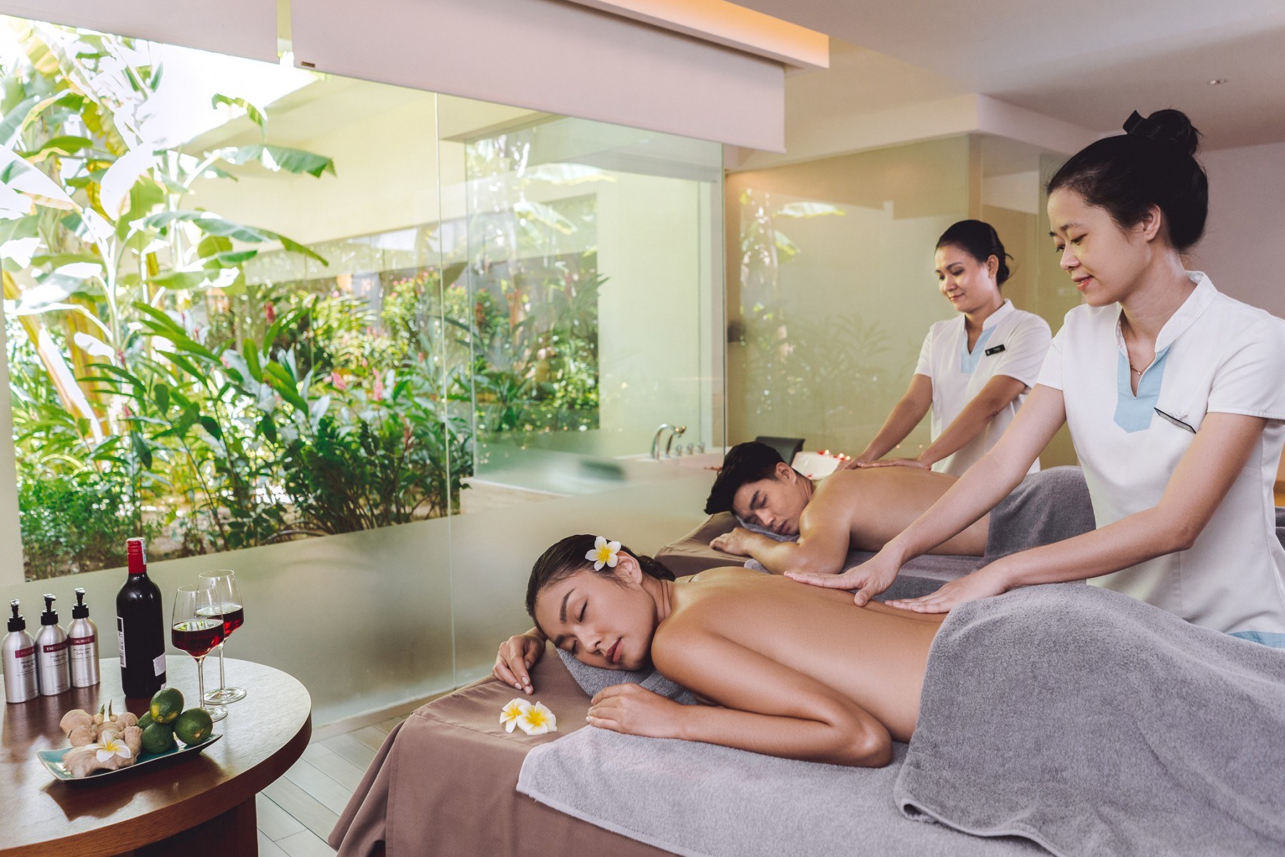 Couples receiving professional massage in a luxury spa room